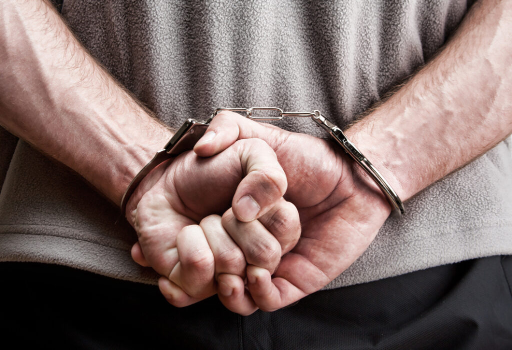 Hands in handcuffs, Robert Wiest Northern Colorado Attorney at Law and Criminal Defense Lawyer.
