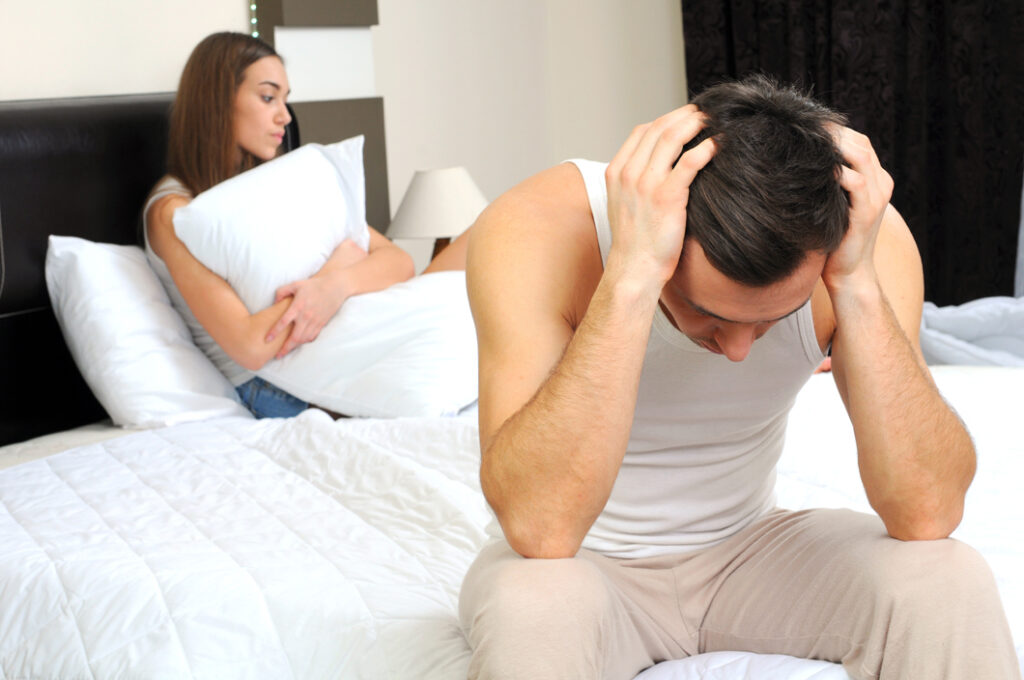 Couple in bed going through relationship problems Robert Wiest Divorce and Separation attorney in Northern Colorado